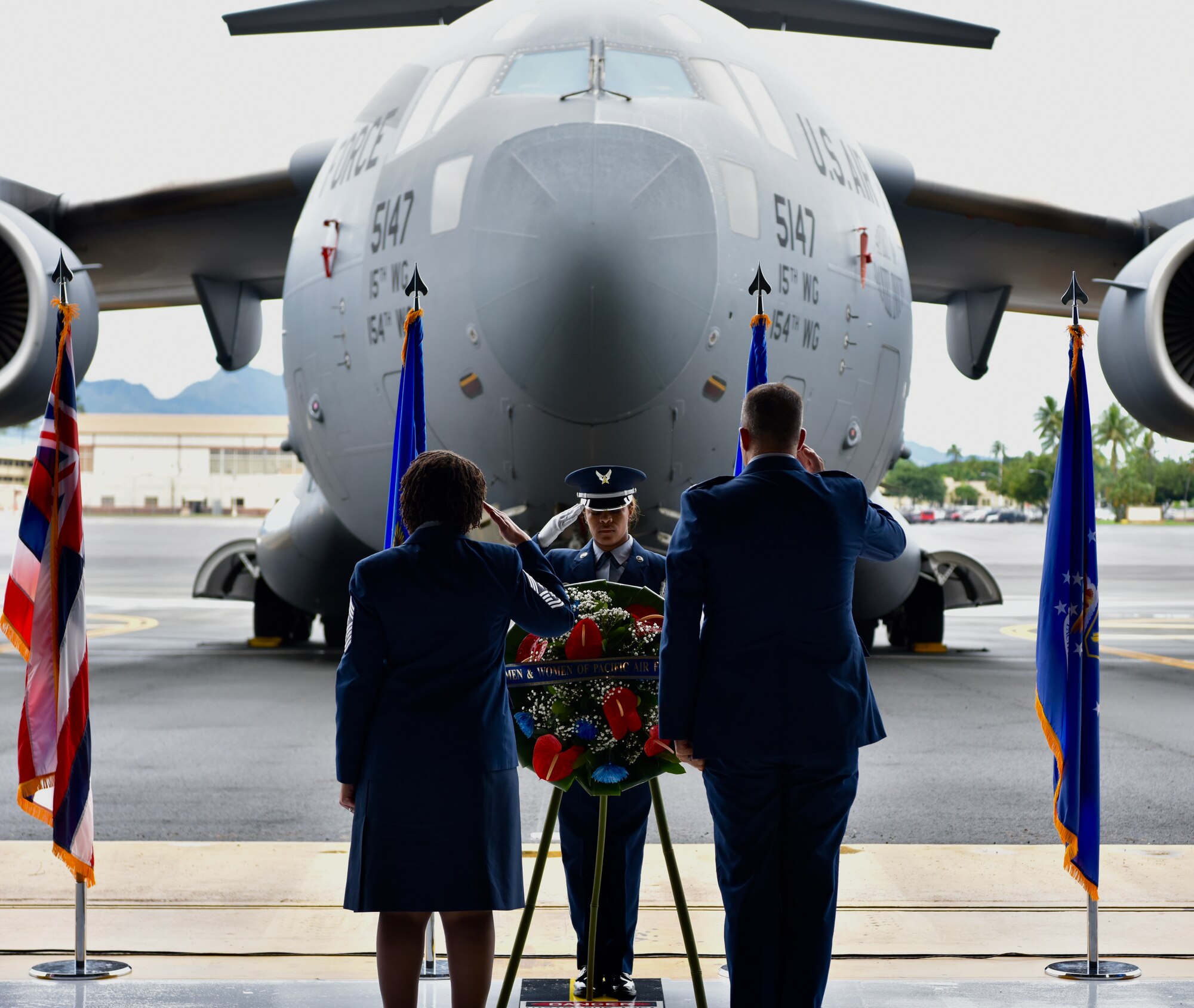 Col. Daniel Dobbels, 15th Wing commander, and Chief Master Sgt. Sheronne King, 15 WG command chief, salute a wreath presented at the December 7th Remembrance Ceremony at Joint Base Pearl Harbor-Hickam, Hawaii, Dec. 7, 2021. This year marked the 80th anniversary of the attacks on Hickam Field and Pearl Harbor. (U.S. Air Force photo by 1st Lt. Benjamin Aronson)