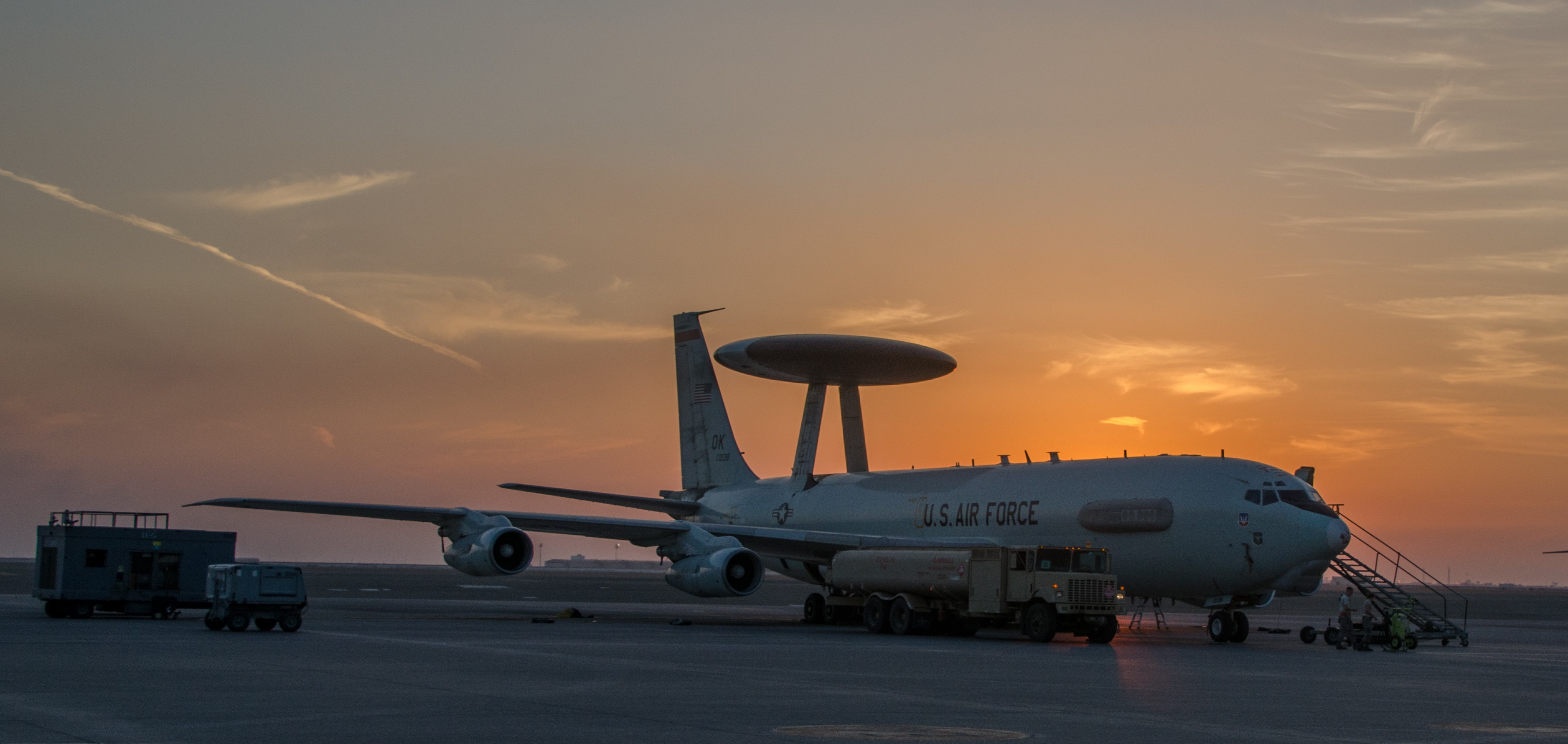 Aircraft on ground in front of sunset