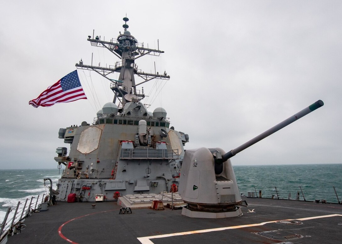 A military ship sails in the ocean.