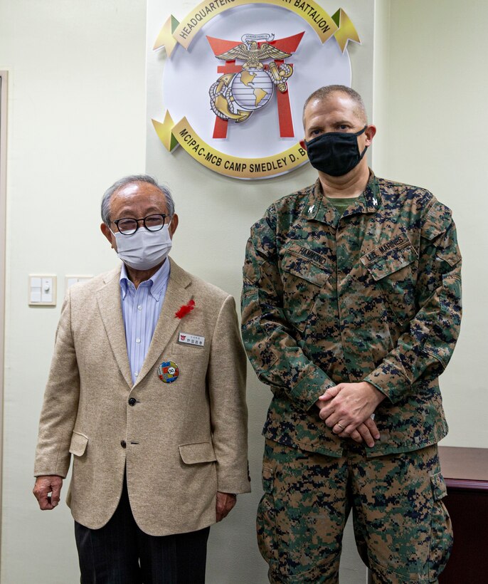Masaharu Noguni, the retiring mayor of Chatan, and U.S. Marine Corps Col. Jeffrey Hammond, the commanding officer of Camps Foster and Lester, and Headquarters and Support Battalion, Marine Corps Installations Pacific, pose for a photo on Camp Foster, Okinawa, Japan, Dec. 3, 2021. After serving 16 years as the mayor of Chatan, Noguni visited Camp Foster to discuss future collaborations and projects with the Marine Corps and to thank Hammond for his friendship and support with the local community. (U.S. Marine Corps photo by Lance Cpl. Alex Fairchild)