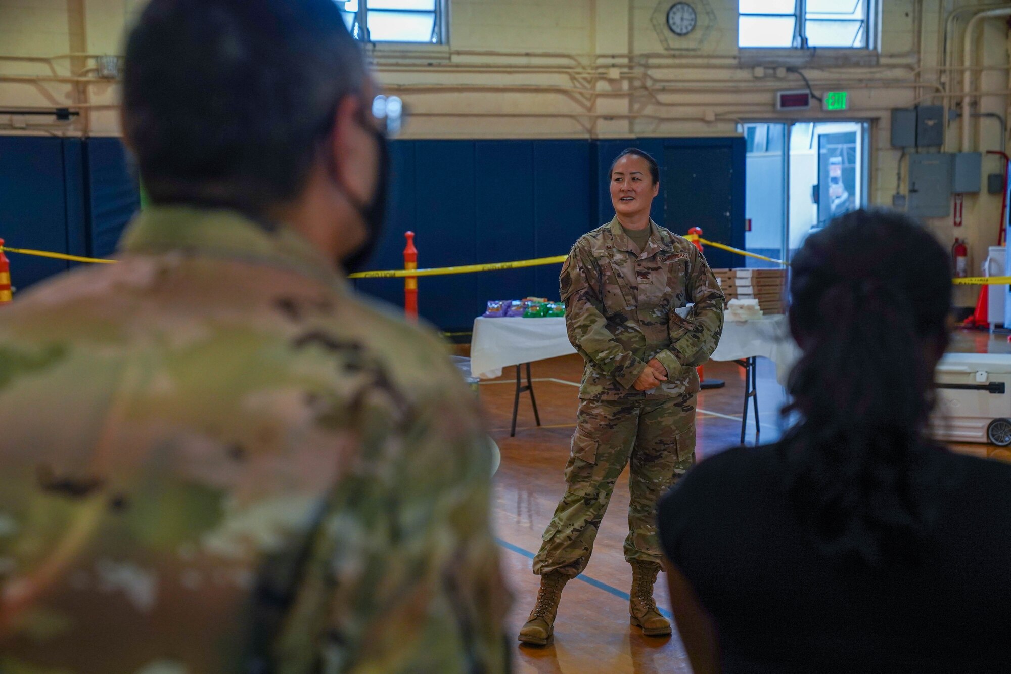 Col. Stephanie Ku, 15th Medical Group commander, briefs Airmen from the 15th MDG before the start of the 30th mass vaccination in the Hickam Memorial Fitness Center at Joint Base Pearl Harbor-Hickam, Hawaii, Nov. 30, 2021. 15th MDG administered more than 19,000 vaccines to Active Duty Airmen and Guardians, contractors, retirees and dependents. (U.S. Air Force photo by Airman 1st Class Makensie Cooper)