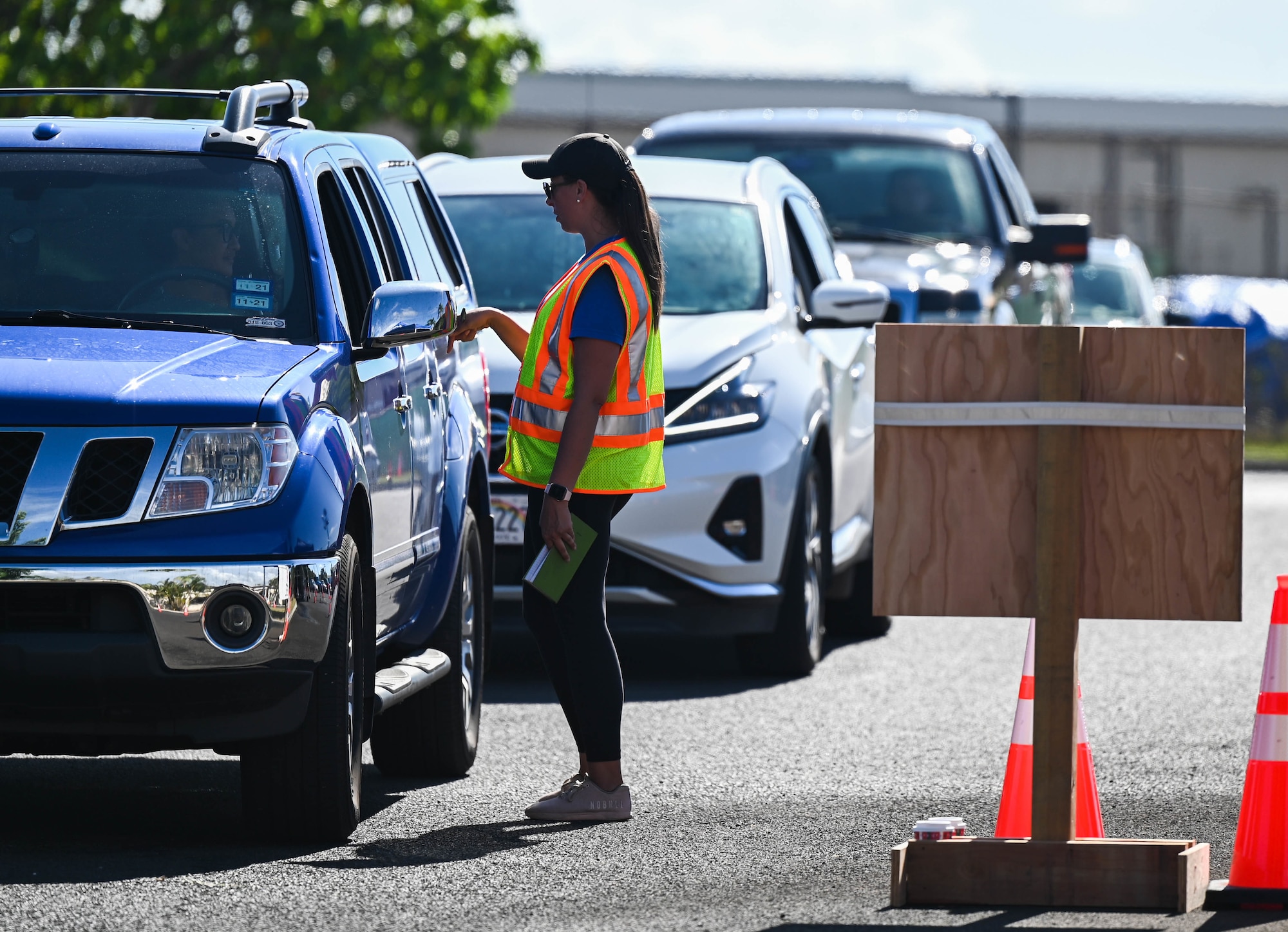 Tech. Sgt. Becca Eisenman, 65 Airlift Squadron flight attendant, inspects identification cards and confirms visitors’ residencies while managing a water distribution point at the Hickam Makai Recreation Center at Joint Base Pearl Harbor-Hickam, Hawaii, Dec. 2, 2021. The water distribution point distributes bottled water from 8 a.m. to 8 p.m. to all impacted members and families. (U.S. Air Force photo by Staff Sgt. Alan Ricker)