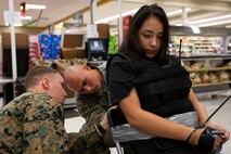 U.S. Marine Corps Sgt. Matthew Stapleford, left, an explosive ordinance disposal technician with Combat Logistics Battalion 3, and Gunnery Sgt. Derrick Vess, an EOD technician with CLB-3, assess a hostage scenario during a drill at the base commissary, Marine Corps Base Hawaii, Dec. 6, 2021. MCBH and CLB-3 EOD, along with the Provost Marshals office participated in an improvised explosive device scenario as part of their annual training requirement. (U.S. Marine Corps photo by Cpl. Samantha Sanchez)