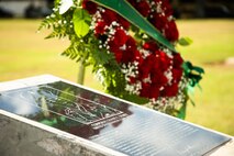 An engraved plaque and flowers are displayed in reverence of Medal of Honor Recipient U.S. Marine Corps Cpl. Duane Dewey, Marine Corps Base Hawaii, Nov. 23, 2021. Dewey was awarded the Medal of Honor for his actions on April 16, 1952, during the Korean War. (U.S. Marine Corps photo by Cpl. Brandon Aultman)