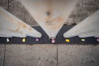 PEARL HARBOR, Hawaii (Dec. 7, 2021) - During the ceremony commemorating the 80th anniversary of the Japanese attack on Pearl Harbor, National Park Service Rangers lay rose petals on each memorial marker representing the 429 Sailors and Marines who lost their lives aboard the USS Oklahoma (BB-37). (U.S. Navy Photo by MC1 Jeffrey Hanshaw/Released).