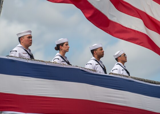 PEARL HARBOR, Hawaii (Dec. 8, 2021) The crew of the Navy's newest guided-missile destroyer, USS Daniel Inouye (DDG 118), man the rails during the commissioning ceremony of USS Daniel Inouye. Homeported at Joint Base Pearl Harbor-Hickam, DDG 118 is the first U.S. Navy warship to honor the Honorable Daniel K. Inouye, a U.S. senator from Hawaii who served from 1962 until his death in 2012. During World War II, Inouye served in the U.S. Army’s 442nd Regimental Combat Team, one of the most decorated military units in U.S. history. For his combat heroism, which cost him his right arm, Inouye was awarded the Medal of Honor. (U.S. Navy photo by Mass Communication Specialist 2nd Class Nick Bauer)