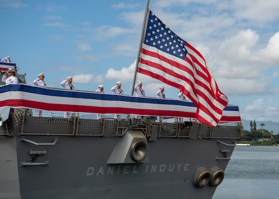 PEARL HARBOR, Hawaii (Dec. 8, 2021) The crew of the Navy's newest guided-missile destroyer, USS Daniel Inouye (DDG 118), man the rails during the commissioning ceremony of USS Daniel Inouye. Homeported at Joint Base Pearl Harbor-Hickam, DDG 118 is the first U.S. Navy warship to honor the Honorable Daniel K. Inouye, a U.S. senator from Hawaii who served from 1962 until his death in 2012. During World War II, Inouye served in the U.S. Army’s 442nd Regimental Combat Team, one of the most decorated military units in U.S. history. For his combat heroism, which cost him his right arm, Inouye was awarded the Medal of Honor. (U.S. Navy photo by Mass Communication Specialist 2nd Class Nick Bauer)