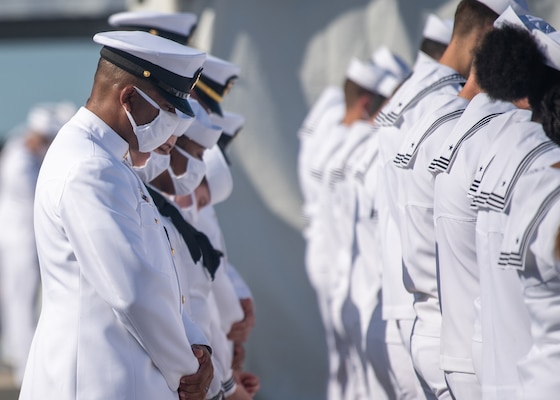 PEARL HARBOR, Hawaii (Dec. 8, 2021)  Sailors bow their heads during the benediction at the commissioning ceremony of USS Daniel Inouye (DDG 118). Homeported at Joint Base Pearl Harbor-Hickam, DDG 118 is the first U.S. Navy warship to honor the Honorable Daniel K. Inouye, a U.S. senator from Hawaii who served from 1962 until his death in 2012. During World War II, Inouye served in the U.S. Army’s 442nd Regimental Combat Team, one of the most decorated military units in U.S. history. For his combat heroism, which cost him his right arm, Inouye was awarded the Medal of Honor. (U.S. Navy photo by Mass Communication Specialist 2nd Class Nick Bauer)