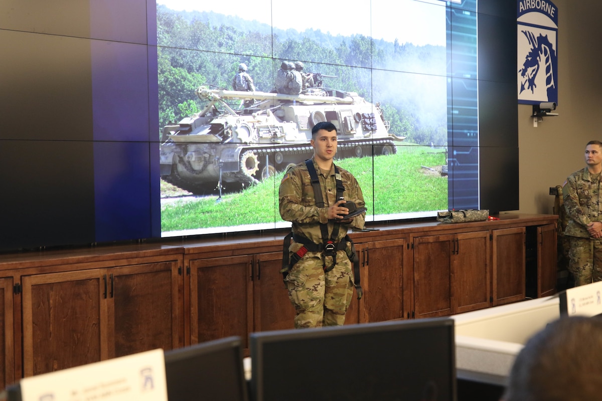 A soldier presents a harness he is wearing.
