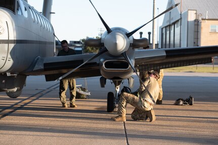 Airmen precheck plane on flightline