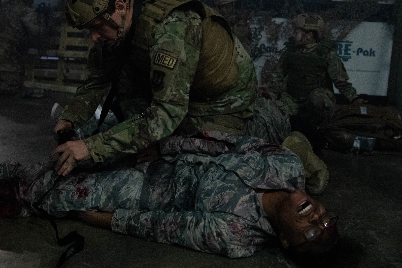 Medical professional applying tourniquet to a simulated patient