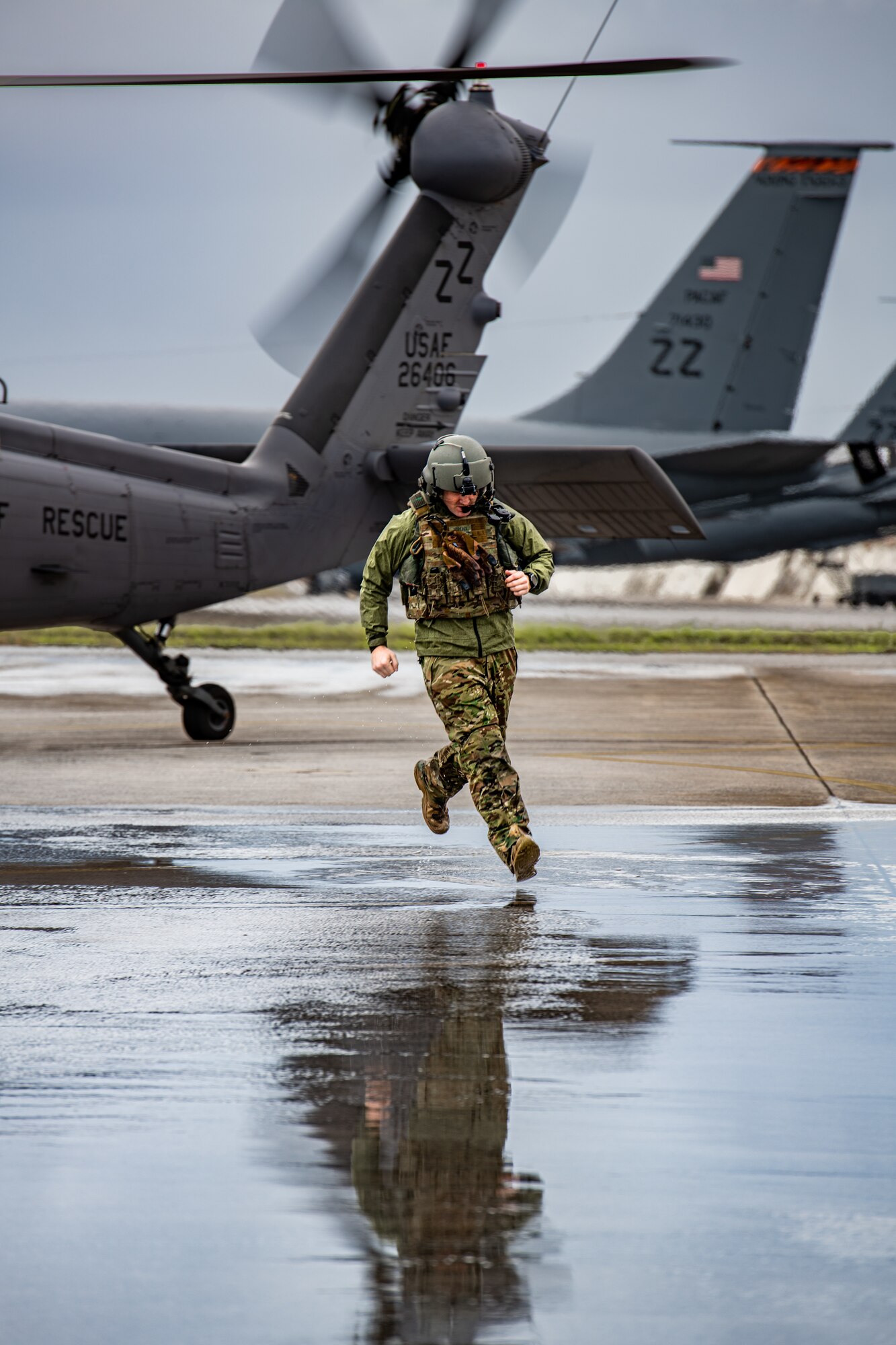 A U.S. Air Force member runs from a helicopter