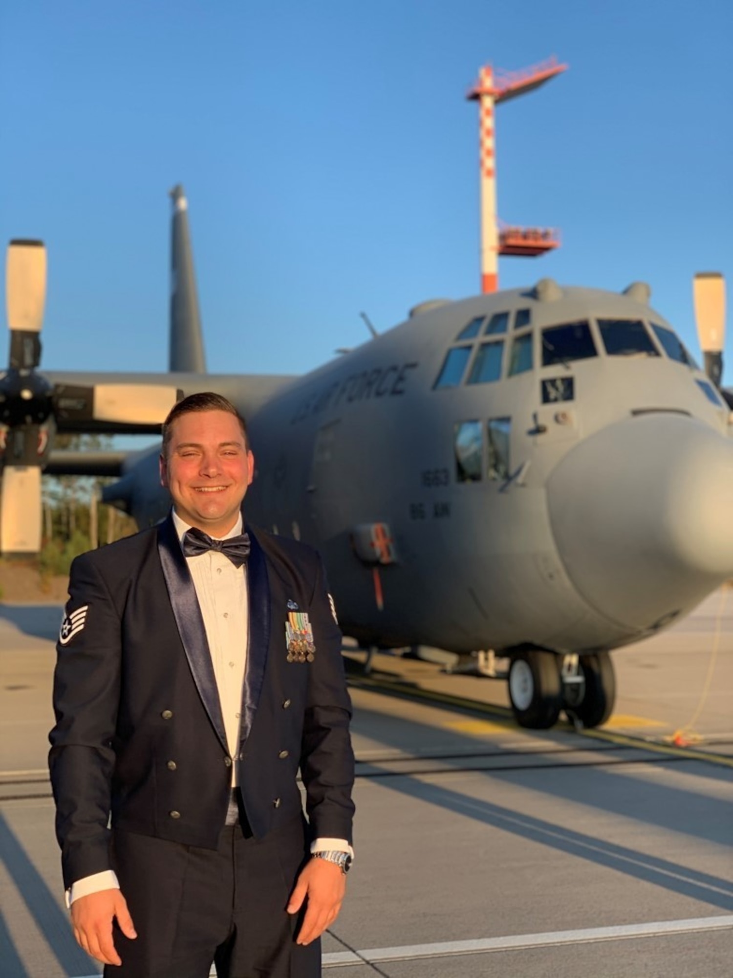 A military member standing next to an aircraft.