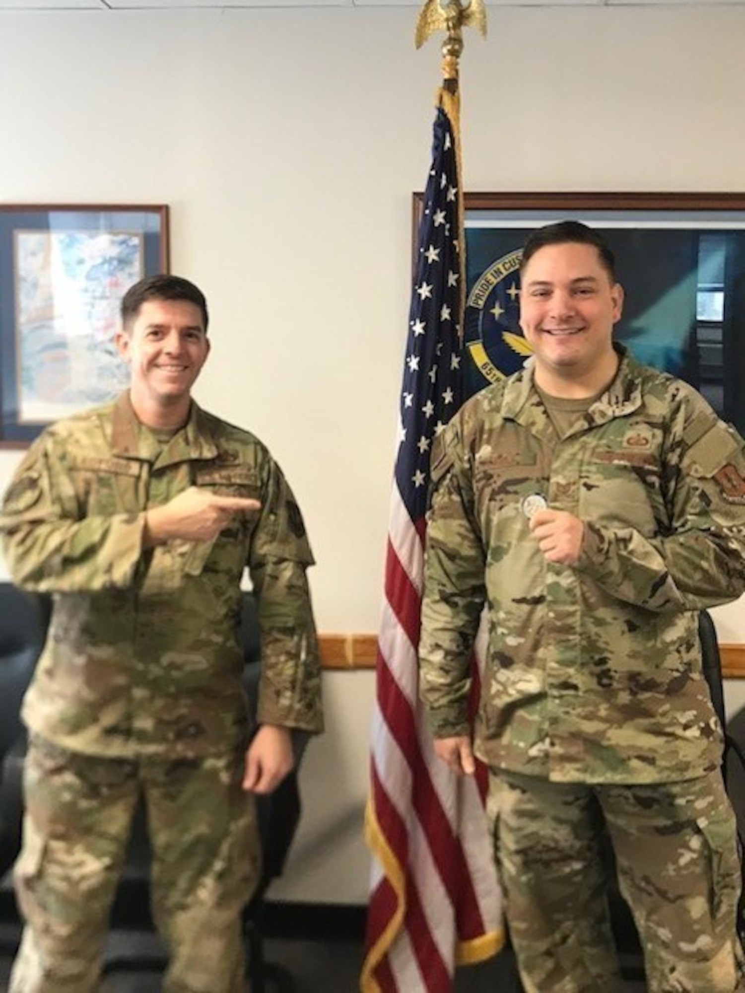 Two military members standing in an office.