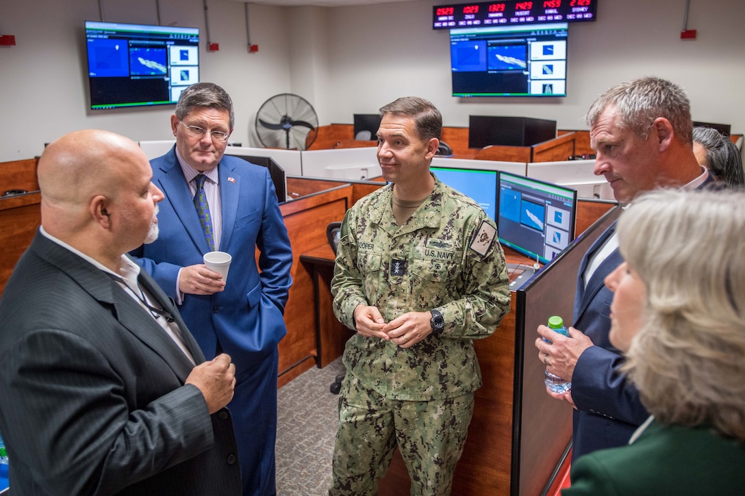 NAVAL SUPPORT ACTIVITY BAHRAIN (Dec. 8, 2021) From the left, Fred Paris, law enforcement co-director of Regional Narcotics Interagency Fusion Cell (RNIFC), Roddy Drummond, U.K. Ambassador to Bahrain, Vice Adm. Brad Cooper, commander of U.S. Naval Forces Central Command (NAVCENT), U.S. 5th Fleet and Combined Maritime Forces (CMF), William J. Warren Jr., Middle East regional director of the Drug Enforcement Agency and Maggie Nardi, charge d’affaires, U.S. Embassy to Bahrain, meet during a ribbon cutting ceremony for the opening of the new interagency counter narcotics facility at Naval Support Activity Bahrain, Dec. 8. The facility will be operated by the RNIFC, a joint Department of Defense and law enforcement team established seven years ago and comprised of personnel from NAVCENT, CMF, and law enforcement agency partners to support maritime and land drug interdiction operations. (U.S. Navy photo by Mass Communication Specialist 2nd Class Mark Thomas Mahmod)