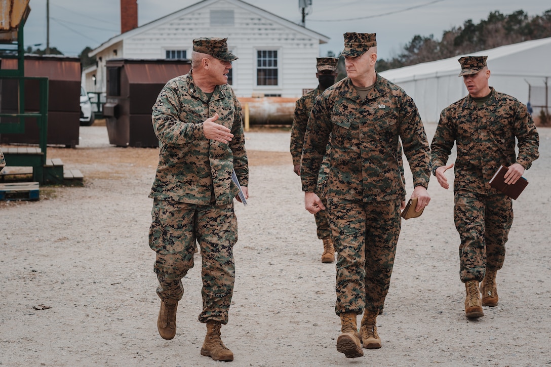 U.S. Marine Corps Col. Dennis W. Sampson, (Left), commanding officer of the 26th Marine Expeditionary speaks with Sgt. Maj. Troy E. Black, (Right), the 19th Sergeant Major of the Marine Corps, while touring an Afghan village on Fort Pickett, Virginia, Dec. 8, 2021.