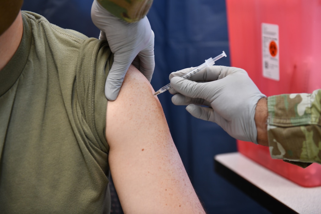 MSgt Maximo Caba administers COVID-19 vaccine