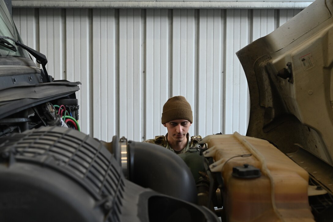 Senior Airman Jason Williams, 30th Security Forces Squadron response force leader, checks the engine of a commercial vehicle during a routine inspection inside the pit at Vandenberg Space Force Base, Calif., Dec. 7, 2021. (U.S. Space Force photo by Airman 1st Class Rocio Romo)