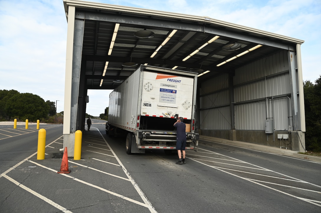 A commercial truck driver closes up his vehicle after being inspected by 30th Security Forces defenders at the pit on Vandenberg Space Force Base, Calif., Dec. 7, 2021. 30th SFS, secure the highly trafficked area for commercial delivery visitors throughout the holiday season. (U.S. Space Force photo by Airman 1st Class Rocio Romo)