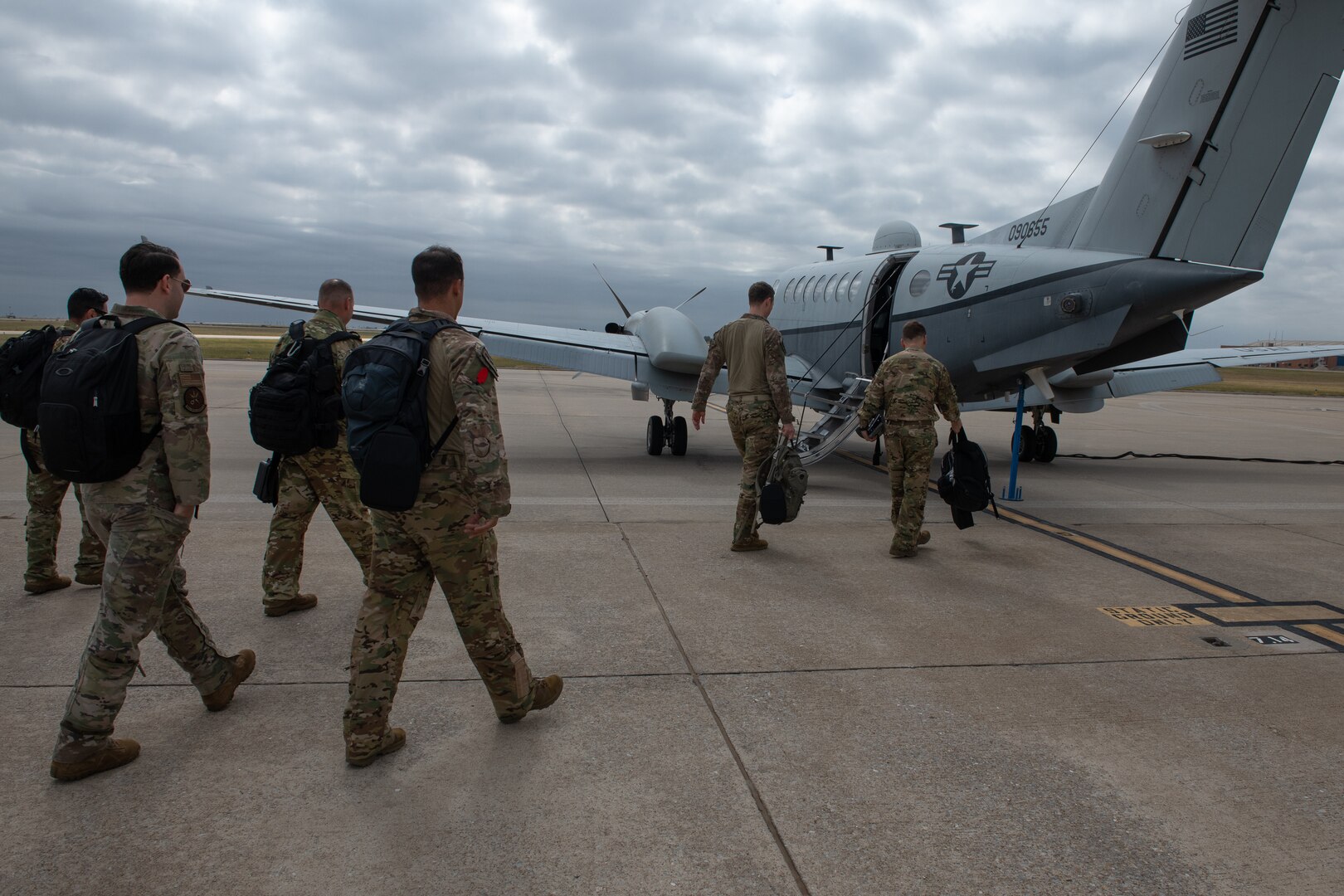 people walk toward a plane