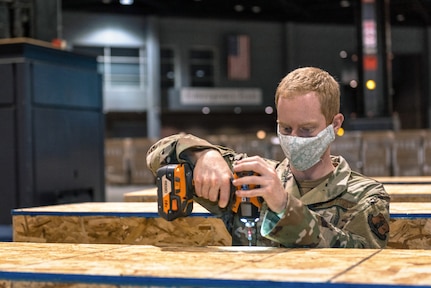 U.S. Air Force Airman 1st Class Dylan Heeter, an operations intelligence specialist with the 182nd Operations Support Squadron, Illinois Air National Guard, reinforces equipment containers at the McCormick Center alternative care facility in Chicago, May 5, 2020. The alternative care facility was built with the help of Illinois National Guardsmen to support the state’s healthcare infrastructure in the event of a patient overflow caused by the COVID-19 pandemic. (U.S. Air National Guard photo by Tech. Sgt. Lealan Buehrer)