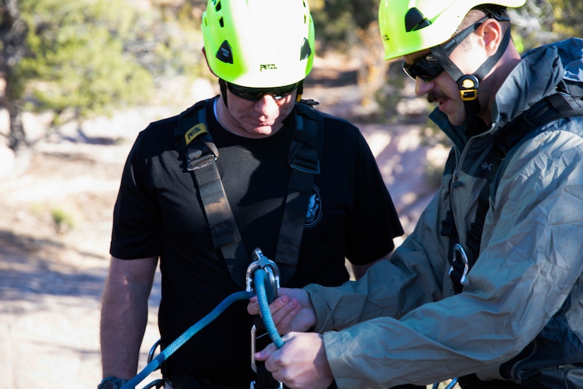 Staff Sgt. Brian Conger, a medic, and Staff Sgt. Bradley Samulsen, an administration clerk, both assigned to the Utah National Guard’s 85th Weapons of Mass Destruction–Civil Support Team, check ropes, knots, and review procedures prior to descending a cliff face in Leeds, Utah, Nov. 17, 2021.