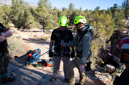 Staff Sgt. Brian Conger, a medic, and Staff Sgt. Bradley Samulsen, an administration clerk, both assigned to the Utah National Guard’s 85th Weapons of Mass Destruction–Civil Support Team, check ropes, knots, and review procedures prior to descending a cliff face in Leeds, Utah, Nov. 17, 2021