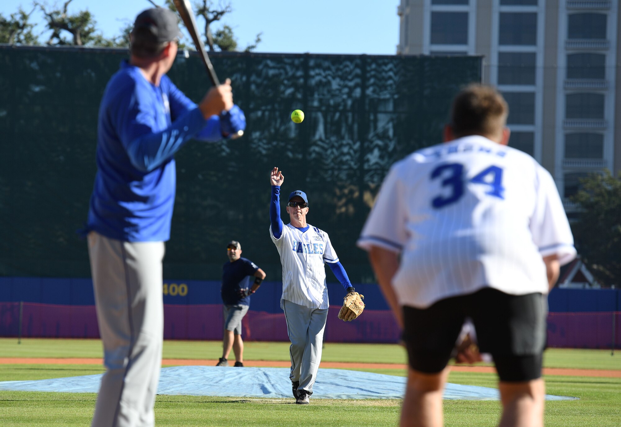 U.S. Air Force Col. William Hunter, 81st Training Wing commander, pitches a softball during the Chiefs vs. Eagles softball game at MGM Park in Biloxi, Mississippi, December 3, 2021. The chief master sergeants and colonels softball match, titled Chiefs vs. Eagles, was preceded by a homerun derby and a military working dog demonstration. (U.S. Air Force photo by Kemberly Groue)