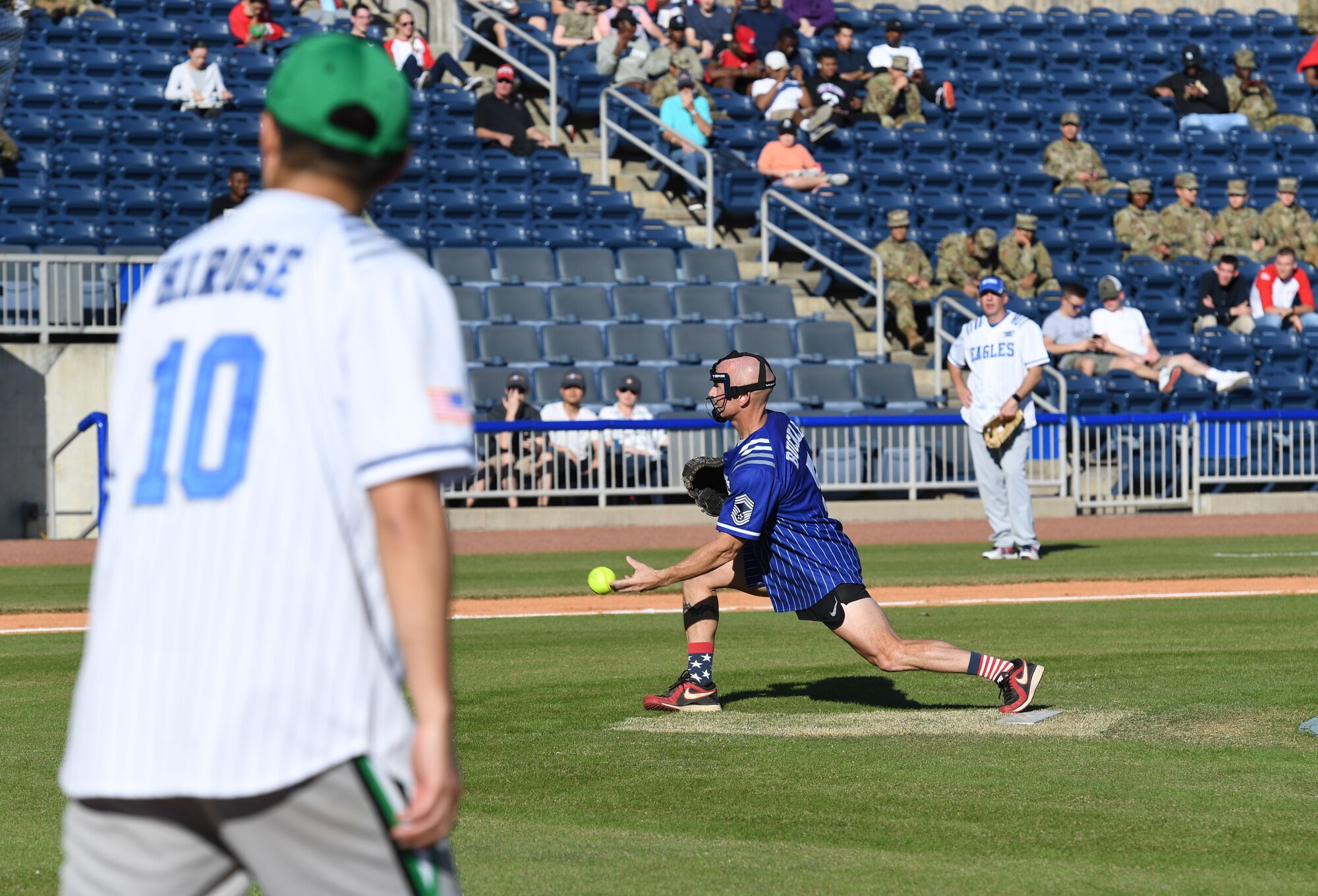 U.S. Air Force Chief Master Sgt. Jason Buckley, 81st Training Group superintendent, launches a softball during the Chiefs vs. Eagles softball game at MGM Park in Biloxi, Mississippi, December 3, 2021. The chief master sergeants and colonels softball match, titled Chiefs vs. Eagles, was preceded by a homerun derby and a military working dog demonstration. (U.S. Air Force photo by Kemberly Groue)