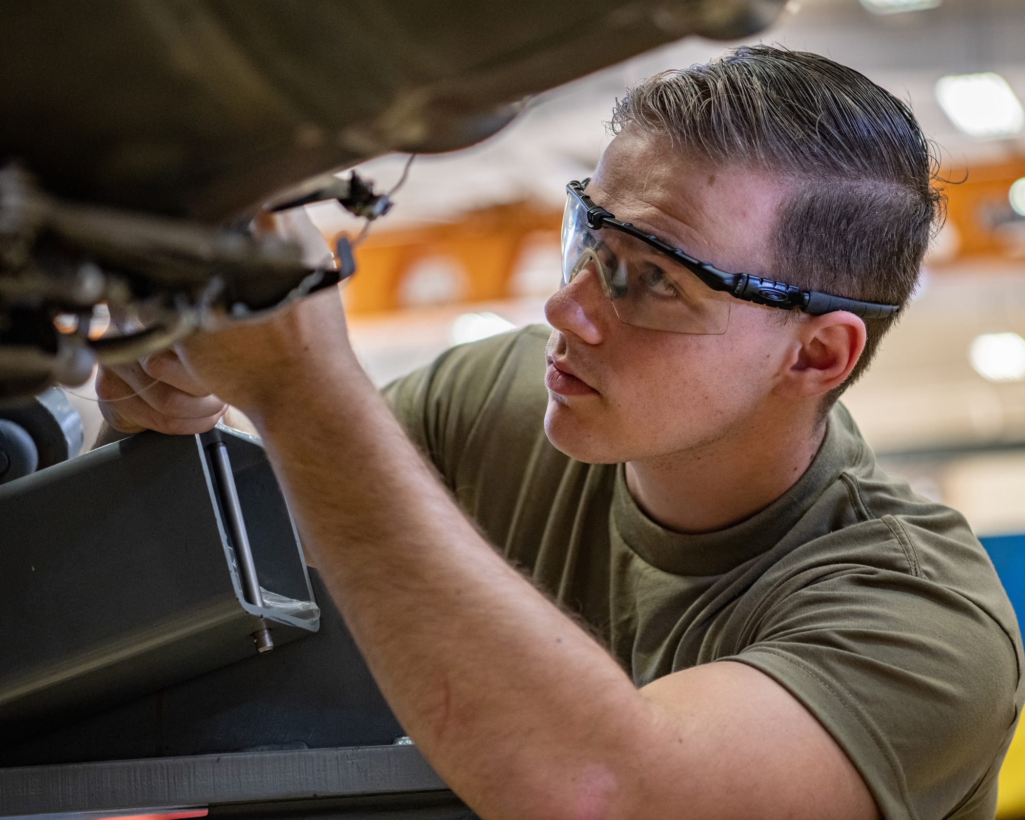 An Airman works on an engine.