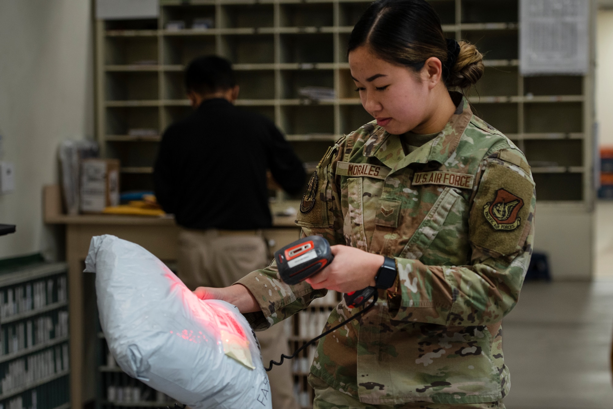 Airman 1st Class Precious Morales, Pacific Air Forces Air Postal Squadron mail processing clerk, scans mail for accountability Dec. 3, 2021, at Yokota Air Base, Japan. During the holiday season, members of the PACAF AIRPS integrate an additional transport vehicle to their daily operations to ensure an increased flow of mail can be sorted and delivered across the region. The squadron oversees operations for a transportation flight and 11 locations across the Pacific to serve more than 355,000 patrons across U.S. Indo-Pacific Command.