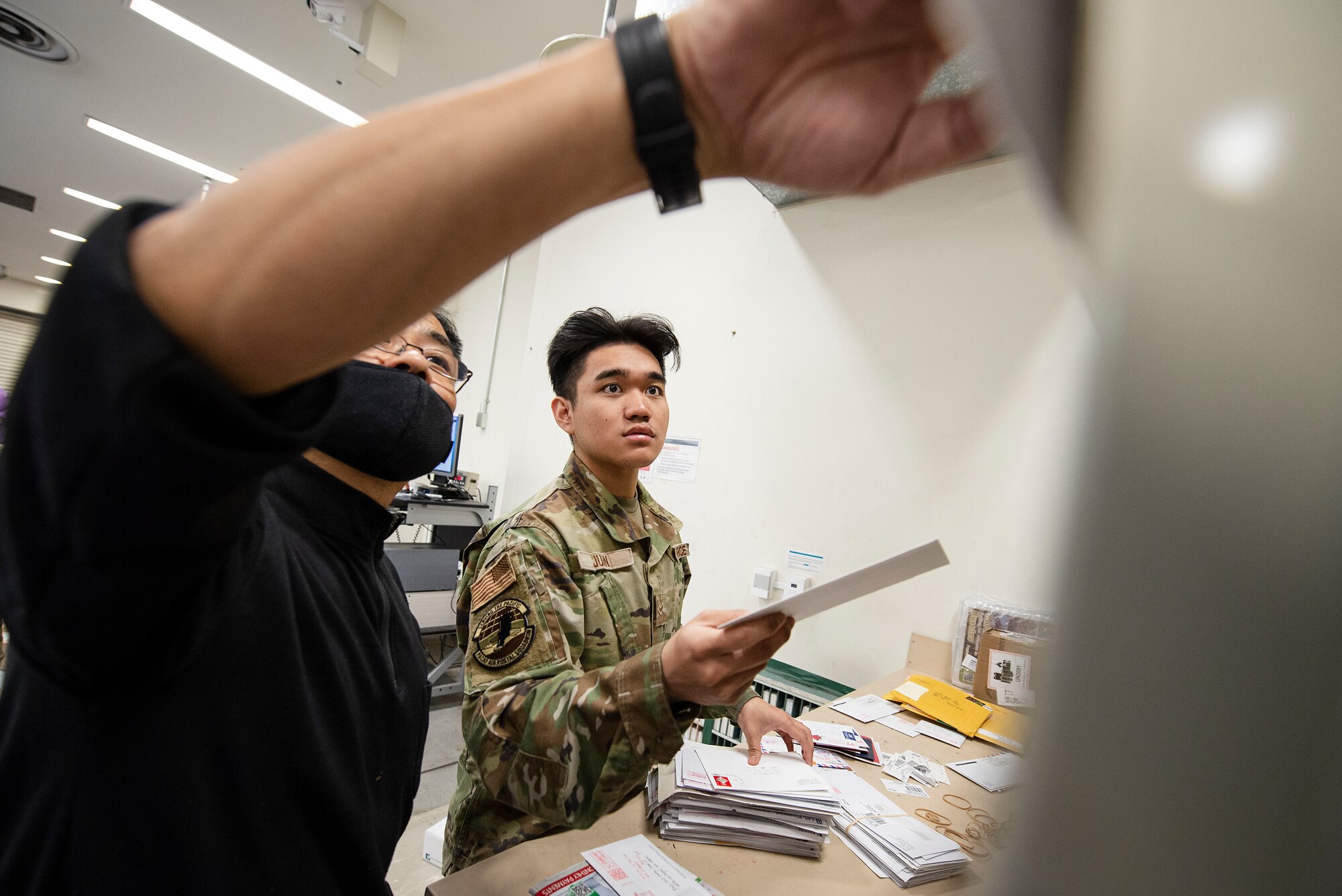 Isamu Endo, left, Pacific Air Forces Air Postal Squadron mail sorting clerk, trains Airman 1st Class Jharell Juan, PACAF AIRPS mail sorting clerk, how to organize mail for its designated zip code Dec. 3, 2021, at Yokota Air Base, Japan. The PACAF AIRPS safeguards and moves mail to its final destination at locations across the Indo-Pacific Region. The squadron oversees operations for a transportation flight and 11 locations across the Pacific to serve more than 355,000 patrons across U.S. Indo-Pacific Command.