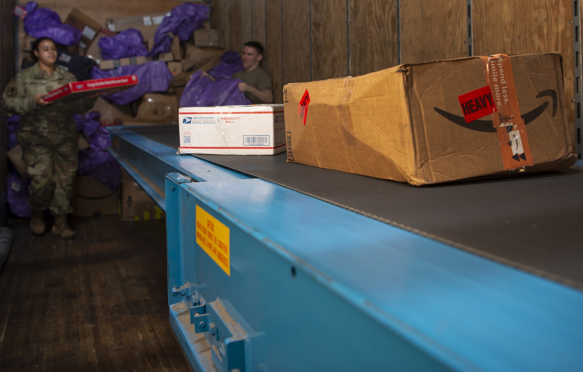 Packages move down a conveyer belt as part of the Pacific Air Forces Air Postal Squadron’s sorting and inspection process Dec. 8, 2021, at Yokota Air Base, Japan. During the holidays, members of the PACAF AIRPS integrate an additional transport vehicle to their daily operations to ensure increased an increased flow of mail can be sorted and delivered across the region. The squadron oversees operations for a transportation flight and 11 locations across the Pacific to serve more than 355,000 patrons across U.S. Indo-Pacific Command.