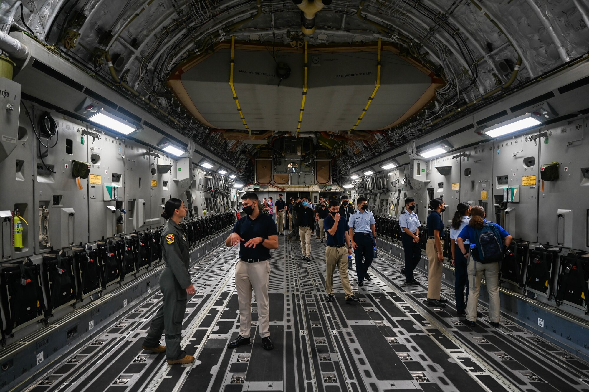 Cadets from the University of Hawaii Air Force Reserve Officer Training Corps explore the fuselage of a C-17 Globemaster III during a base tour at Joint Base Pearl Harbor-Hickam, Hawaii, Dec. 3, 2021. The two-hour tour included two static airframes, an aircrew flight equipment demonstration and an officer panel. (U.S. Air Force photo by Staff Sgt. Alan Ricker)
