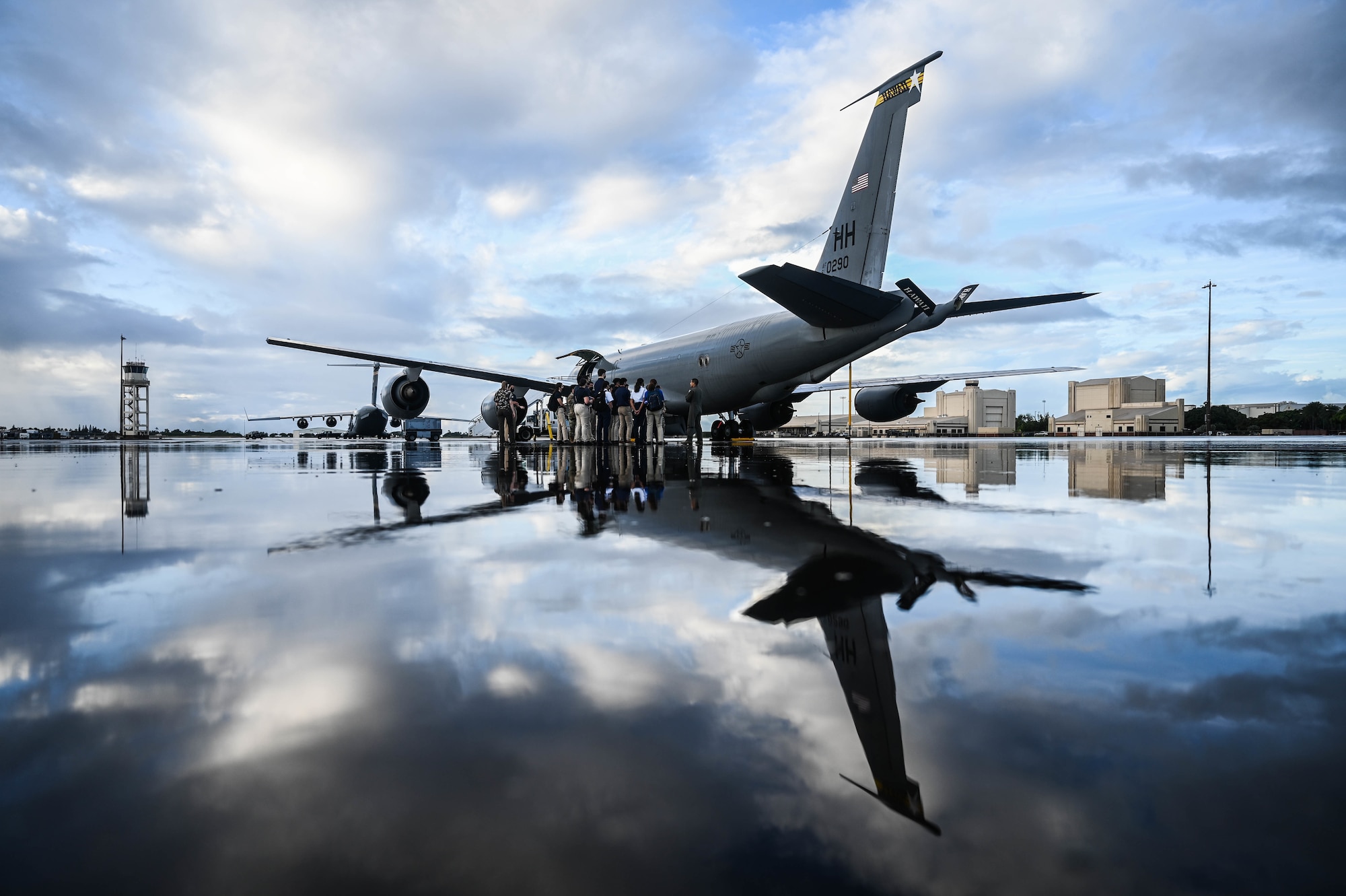 Cadets from the University of Hawaii Air Force Reserve Officer Training Corps listen to a briefing before entering a KC-135 Stratotanker during a base tour at Joint Base Pearl Harbor-Hickam, Hawaii, Dec. 3, 2021. Airmen assigned to the 15th Wing and Guardsmen from the Hawaii Air National Guard showcased their capabilities in support of the C-17 Globemaster III and the KC-135 to more than 40 cadets. (U.S. Air Force photo by Staff Sgt. Alan Ricker)