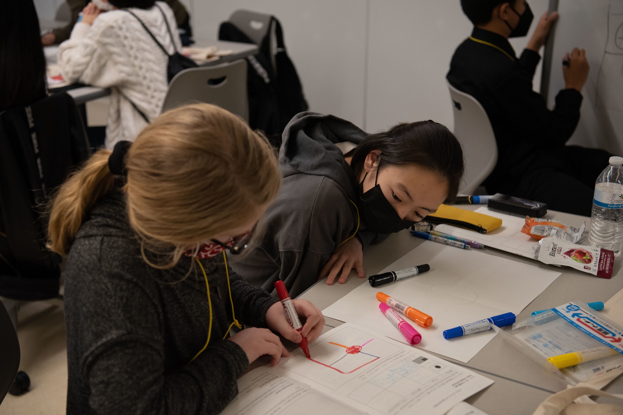 Students in a group work on a project together.