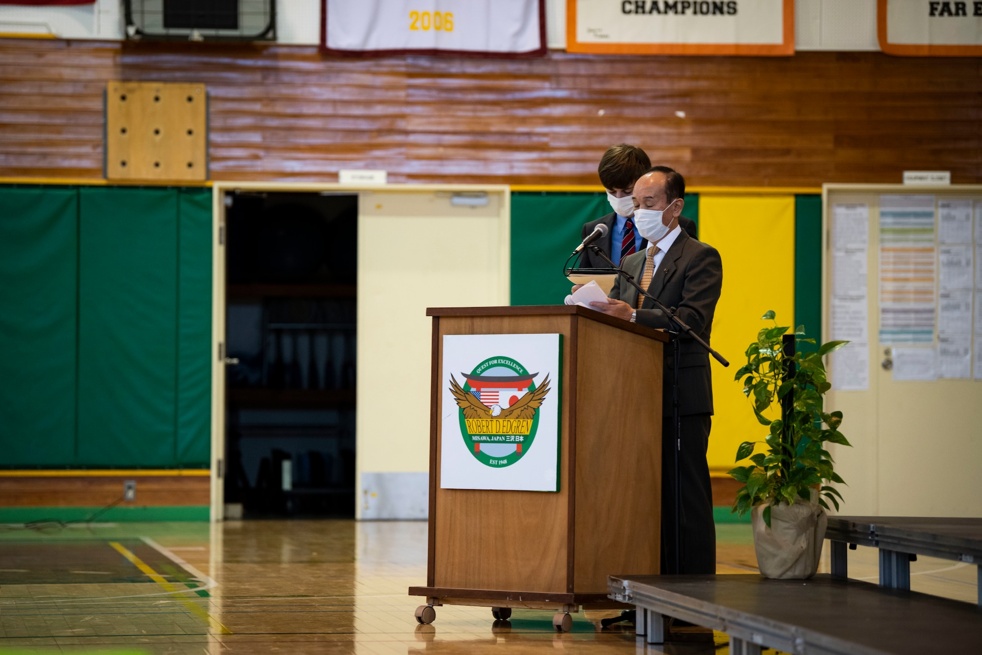 A government official speaks in front of a podium.