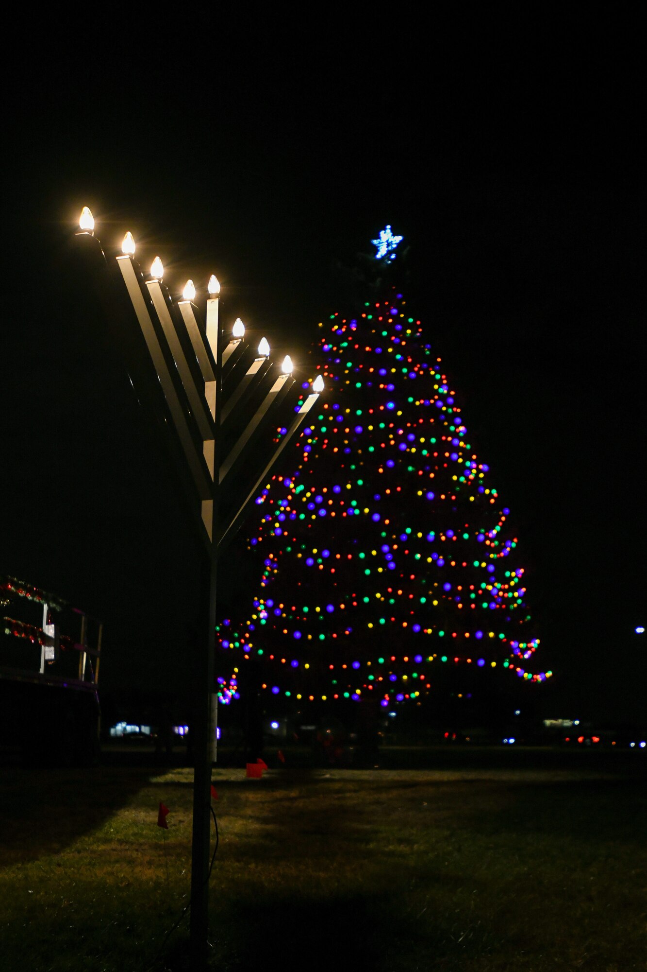 The Christmas tree and Hanukkah Menorah light up during the annual Holiday Extravaganza hosted by Chapel 1 at Joint Base Andrews, Md., Dec. 2, 2021.