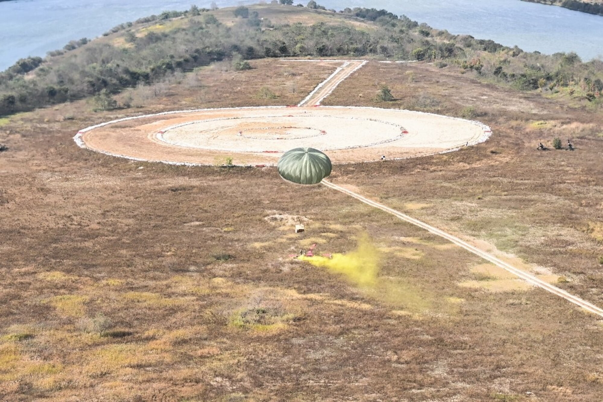 A pallet attached to a parachute makes its way to a drop zone during Operation Christmas Drop training in the Republic of Korea October 22, 2021. This is the first year the Republic of Korea and U.S. have teamed up for the longest running Department of Defense humanitarian and disaster relief training mission which reaches more than 20,000 people annually. (Courtesy photo from Republic of Korea Air Force)