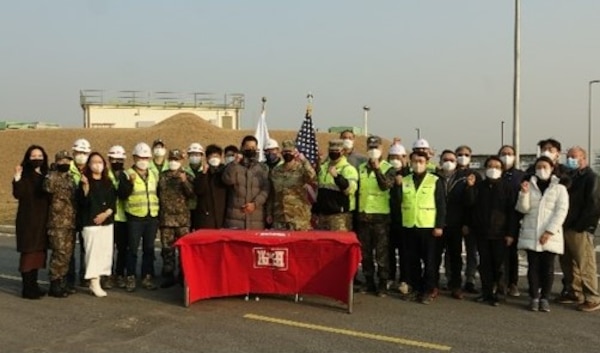 Members of the Project Delivery Team pose for a group photo to commemorate the completion of project CY13 ROKFC IN-KIND Bulk Fuel Storage Tanks and Pumps (OS031) after an Acceptance Release Letter ceremony in Pyeongtaek, Republic of Korea, Dec. 7.