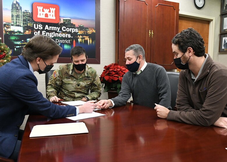 U.S. Army Corps of Engineers Nashville District Project Planning Branch Chief Craig Carrington, USACE Plan Formulation Section Chief Thomas Herbert, and USACE Planning Project Manager Chris Pickering go over the Project Partnership Agreement for the K.R. Harrington Water Treatment Plant Streambank Stabilization Project with Nashville District Commander Joseph Sahl at the Estes Kefauver Federal Building in Nashville, Tennessee.