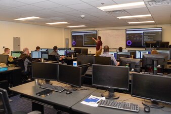 Pete Hay, instructional lead for SimSpace, reviews concepts from the current lesson for the train-the-trainer Cyber Defense Analyst Basic Course at Information Warfare Training Center Corry Station, Dec. 8, 2021.