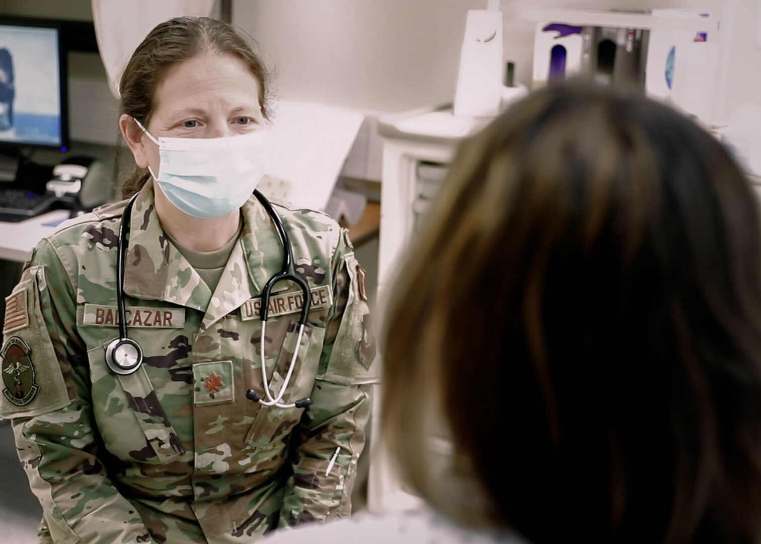 U.S. Air Force Maj. Leslie Balcazar, chief, midwifery services, Landstuhl Regional Medical Center, evaluates a patient during a routine exam at LRMC's Obstetrics and Gynecology Clinic, Nov. 3. Balcazar, a breast cancer survivor, shared her battle with one of the deadliest cancers for women in various platforms throughout October, Breast Cancer Awareness Month.