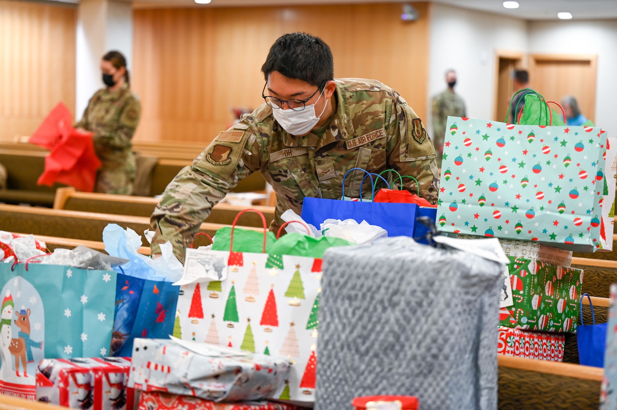 Airman 1st Class John Oh, 75th Communications and Information Directorate, sorts donated Angel Tree program gifts at the base chapel Dec. 9, 2021, at Hill Air Force Base, Utah. The base's Angel Tree program benefits military families anonymously nominated by the first sergeants. (U.S. Air Force photo by Cynthia Griggs)