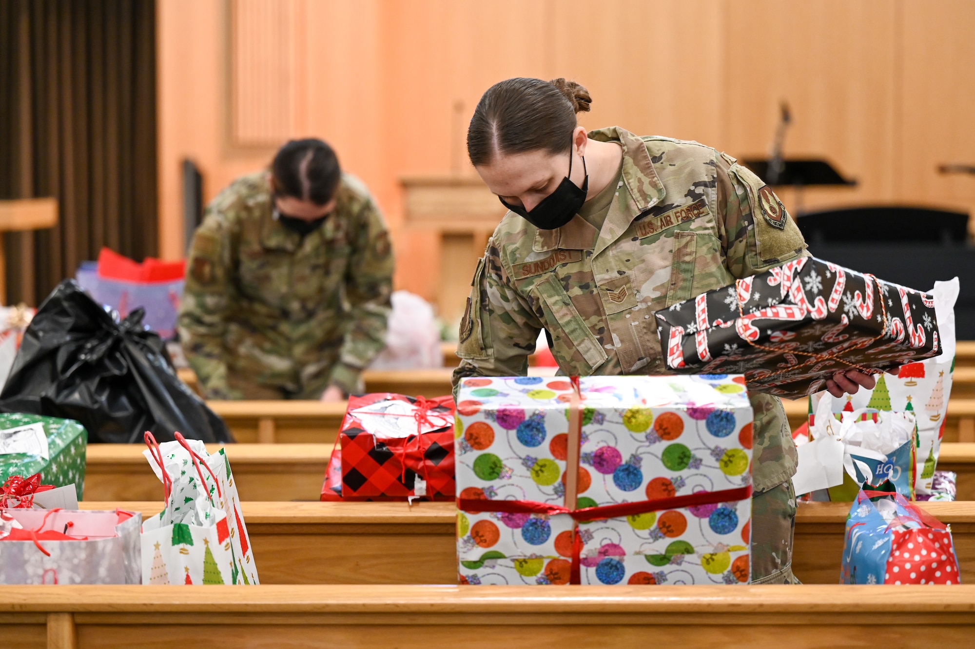 Staff Sgt. Breanne Sundquist and Senior Airman Savana Kirschner, 75th Air Base Wing legal office, sort donated Angel Tree program gifts at the base chapel Dec. 9, 2021, at Hill Air Force Base, Utah. The base's Angel Tree program benefits military families anonymously nominated by the first sergeants. (U.S. Air Force photo by Cynthia Griggs)