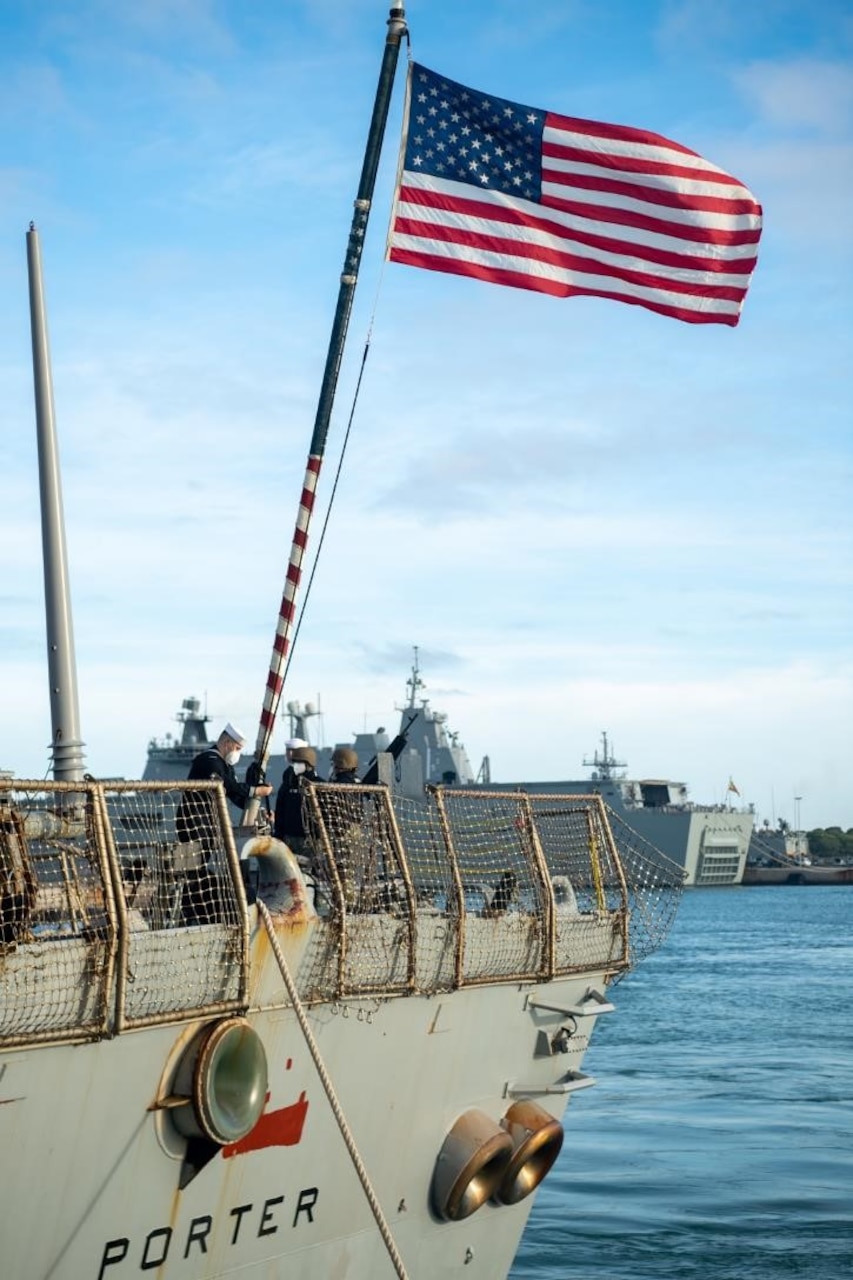 211210-N-RY670-1101 
NAVAL STATION ROTA, Spain (Dec. 10, 2021) A Sailor raises the national ensign aboard the Arleigh Burke-class guided-missile destroyer USS Porter (DDG 78) as the ship concludes its 10th patrol in the U.S. Sixth Fleet area of operations in support of U.S. national security interests in Europe and Africa. (U.S. Navy photo by Mass Communication Specialist 2nd Class Jacob Owen)