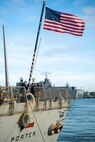 211210-N-RY670-1101 
NAVAL STATION ROTA, Spain (Dec. 10, 2021) A Sailor raises the national ensign aboard the Arleigh Burke-class guided-missile destroyer USS Porter (DDG 78) as the ship concludes its 10th patrol in the U.S. Sixth Fleet area of operations in support of U.S. national security interests in Europe and Africa. (U.S. Navy photo by Mass Communication Specialist 2nd Class Jacob Owen)