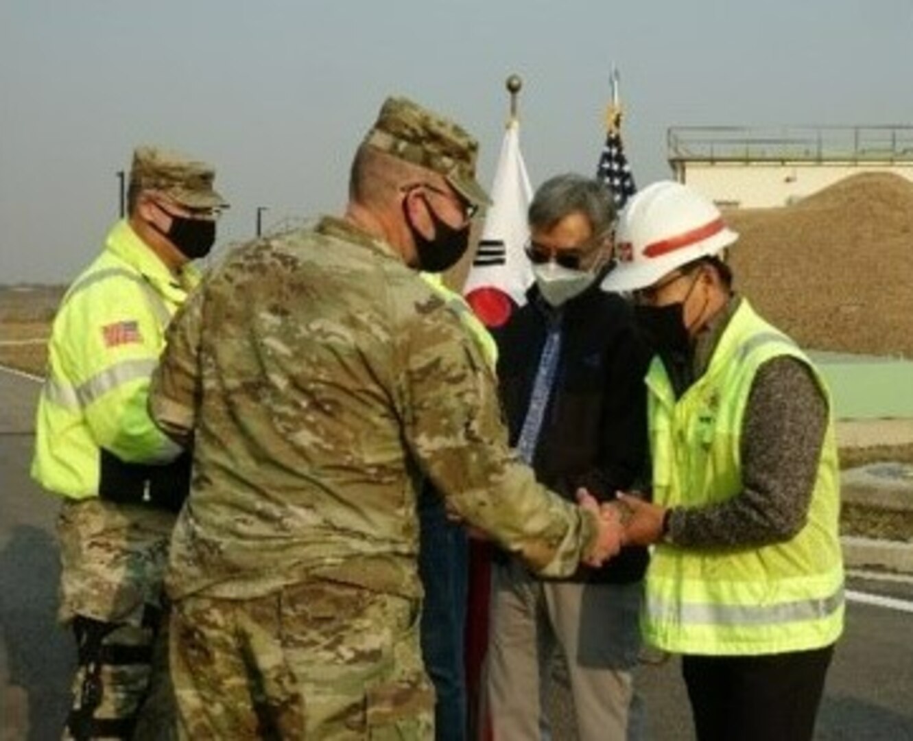 Col. Christopher Crary, FED commander and Col. Garrett Cottrell, U.S. Design and Construction Agent, thanks the project delivery team for a successful completion of project CY13 ROKFC IN-KIND Bulk Fuel Storage Tanks and Pumps (OS031), during an Acceptance Release Letter ceremony, in Pyeongtaek, Republic of Korea, Dec. 7.