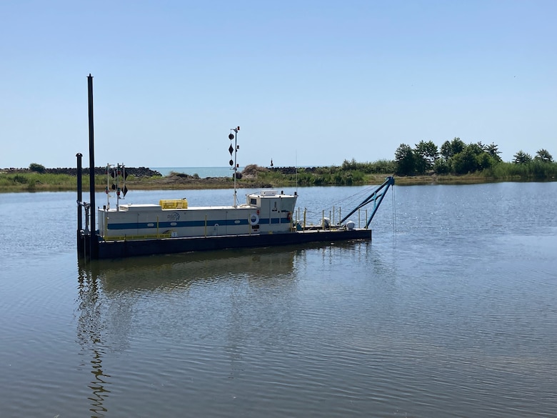 Photo shows a dredge operating in a waterway