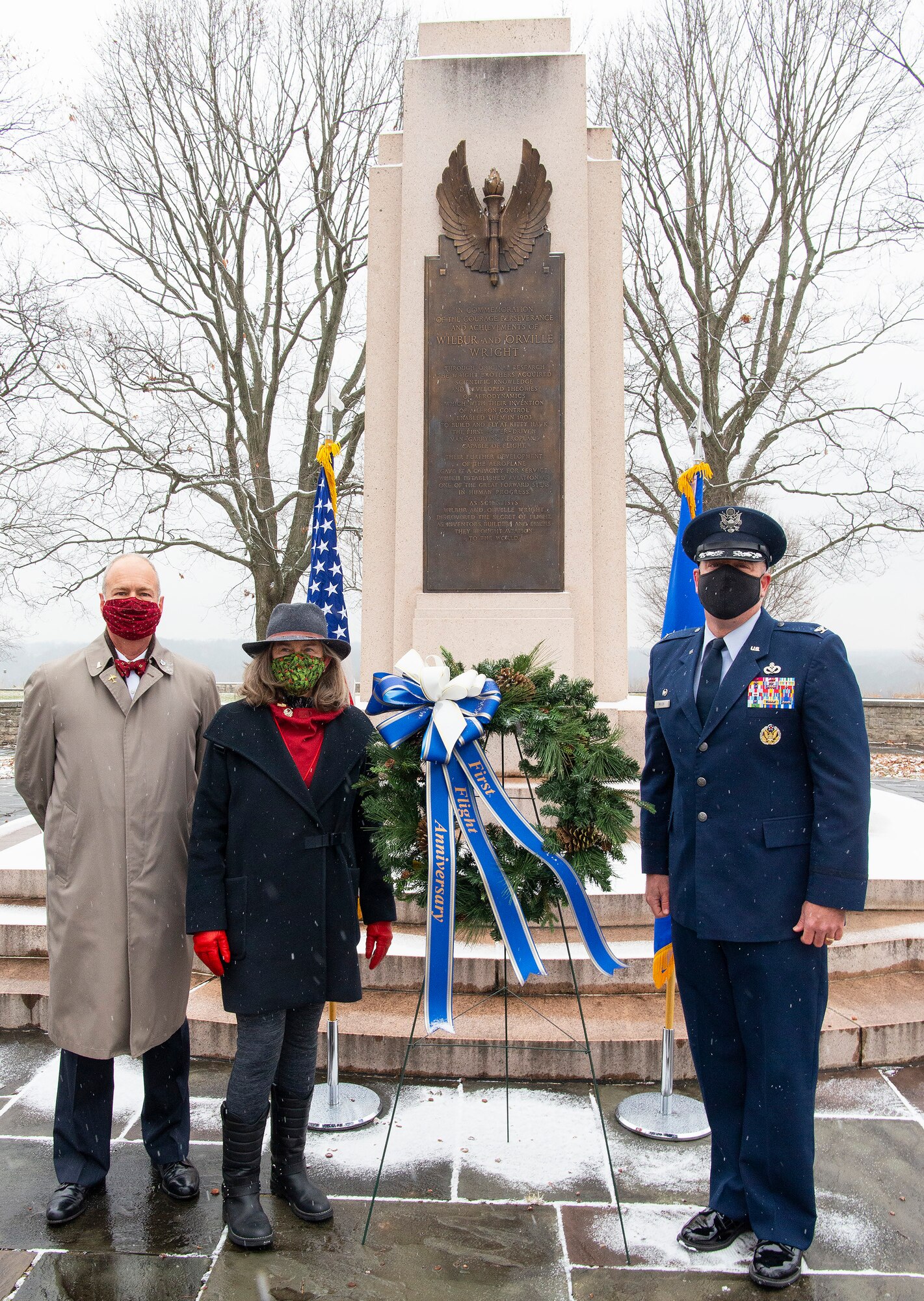 Amanda Wright Lane and Stephen Wright, great-grandniece and grandnephew of the Wright brothers, and Col. Patrick Miller, 88th Air Base Wing and installation commander, lay a wreath at the Wright Brothers Memorial Dec. 17, 2020, during the annual anniversary of the first flight ceremony held on Wright-Patterson Air Force Base, Ohio. The memorial overlooks Huffman Prairie where the Wright Brothers taught themselves and others how to fly. (U.S. Air Force photo by R.J. Oriez)